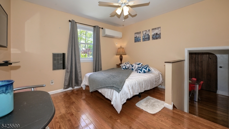 178 Jackson Avenue Rutherford, NJ 07070 - Photo 17 of 29 a bedroom with a large bed and a chandelier