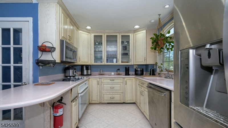 178 Jackson Avenue Rutherford, NJ 07070 - Photo 10 of 29 a kitchen with a sink stove and refrigerator