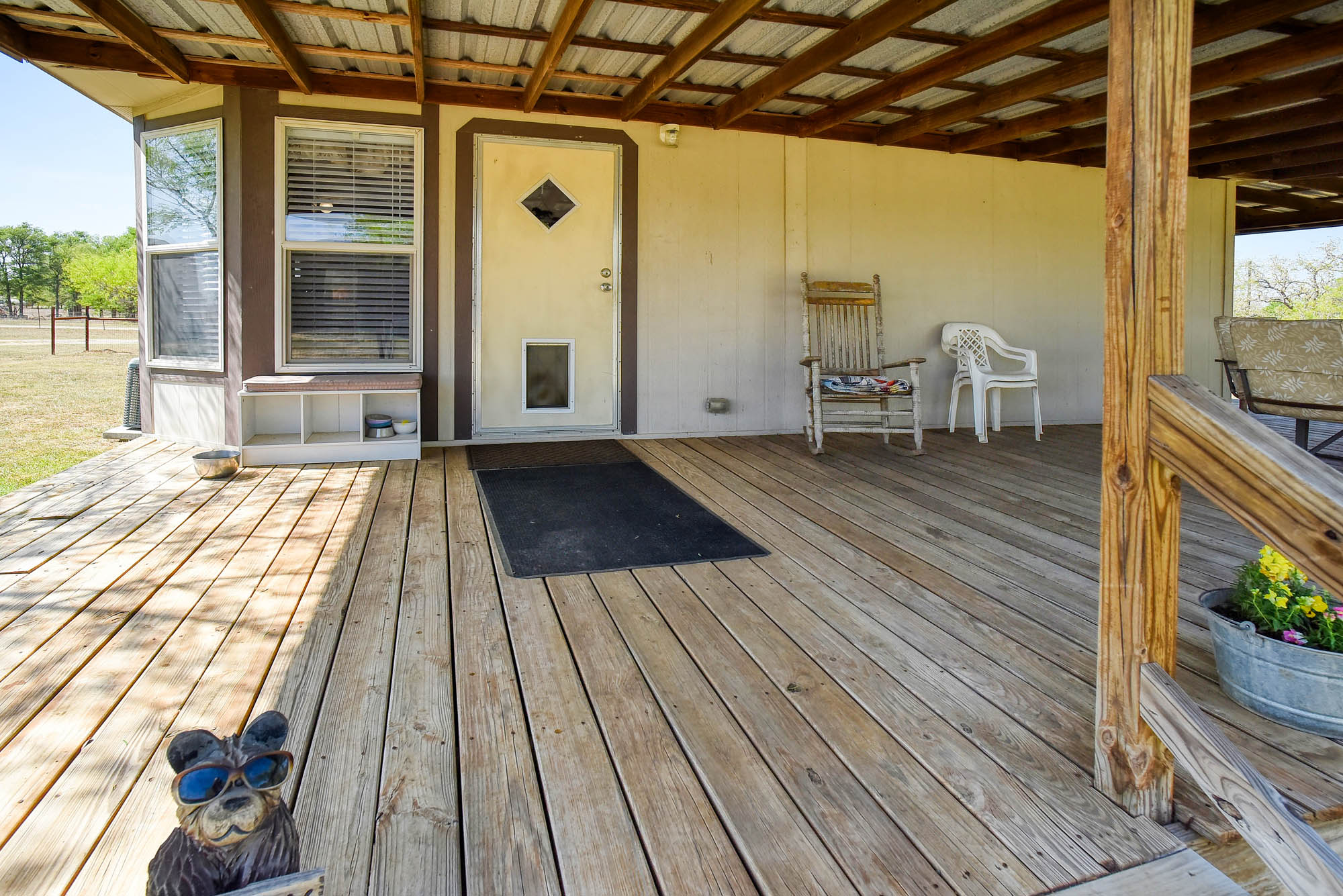 4495 Taylorsville Road Red Rock, TX 78662 - Photo 7 of 40 The generous covered porch offers so many benefits, regardless of the weather.