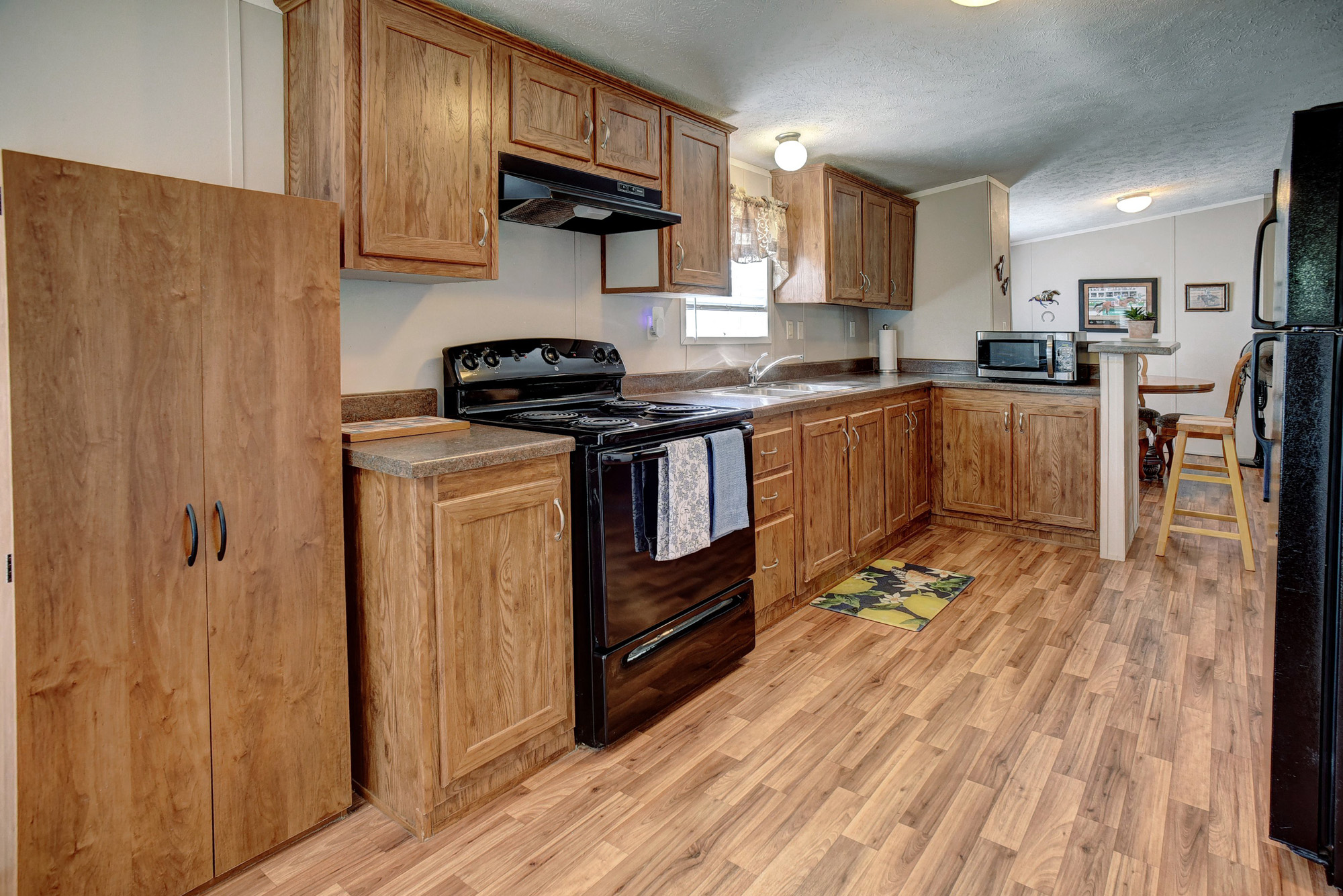 4495 Taylorsville Road Red Rock, TX 78662 - Photo 9 of 40 The natural wood cabinetry provides plenty of storage and lends a warm, welcoming vibe as well.