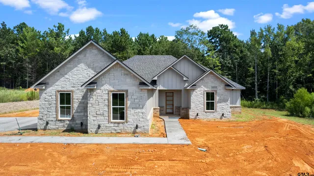 a view of a house with yard and sitting area