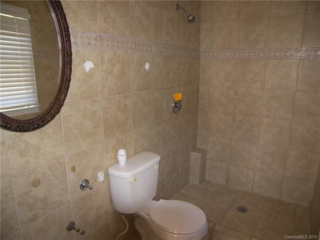 6200 Running Deer Road Charlotte, NC 28214 - Photo 6 of 17 a white toilet sitting next to a bathroom sink