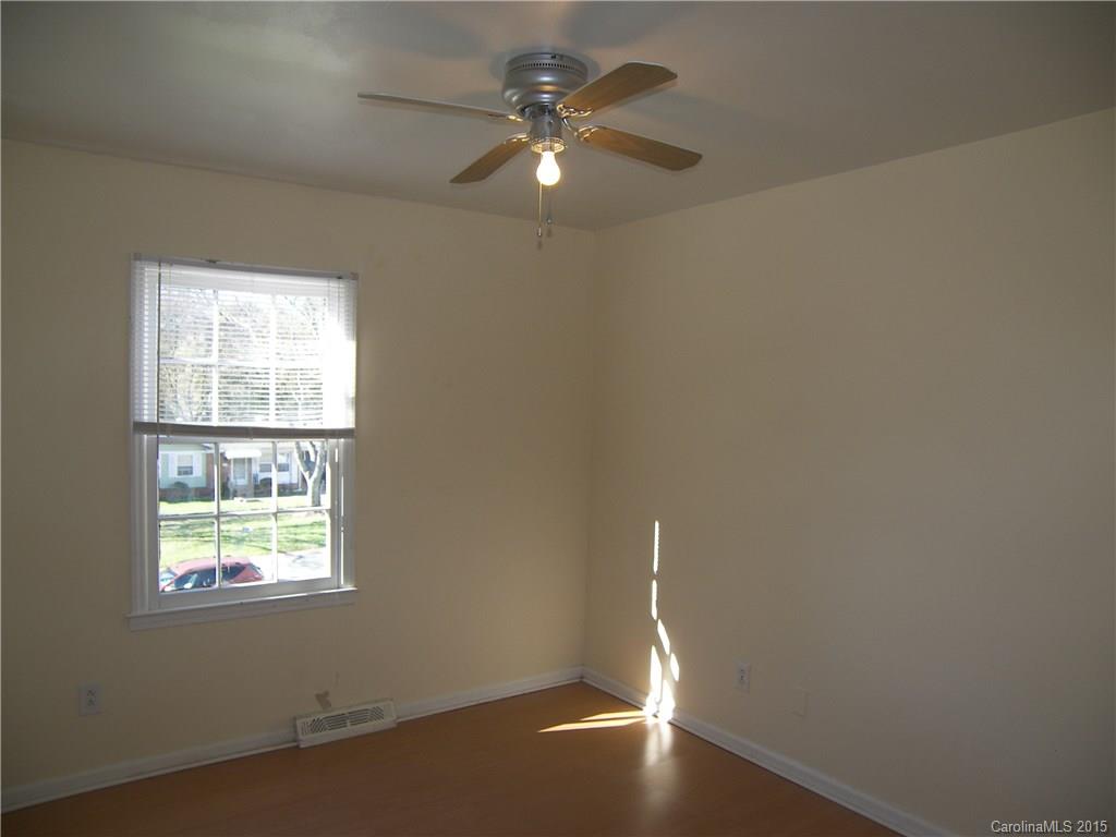 6200 Running Deer Road Charlotte, NC 28214 - Photo 8 of 17 an empty room with a window and a ceiling fan