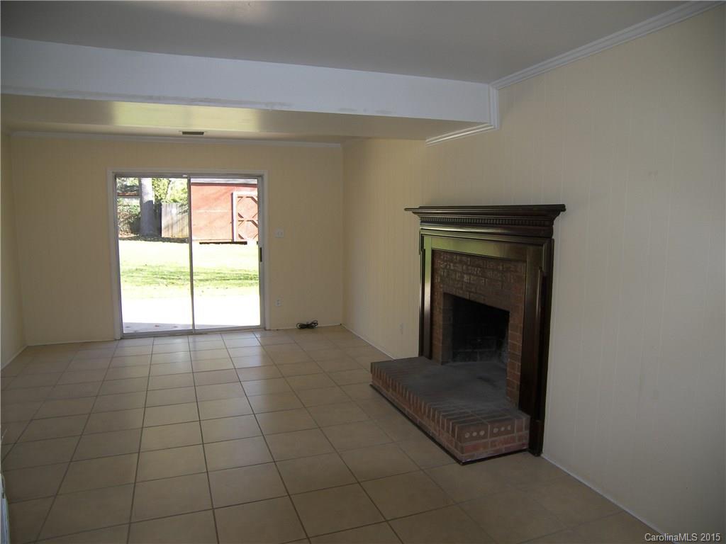 6200 Running Deer Road Charlotte, NC 28214 - Photo 10 of 17 a living room with a fireplace and a window