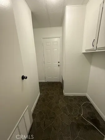 a kitchen with kitchen island white cabinets and granite counter tops