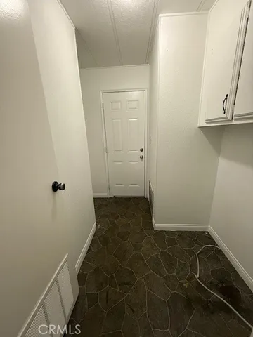 a kitchen with kitchen island white cabinets and granite counter tops