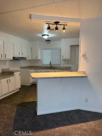 a kitchen with a sink cabinets and window