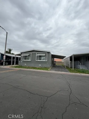 a view of a house with a yard and sitting area