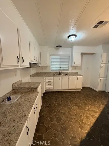 a kitchen with stainless steel appliances granite countertop a sink and cabinets