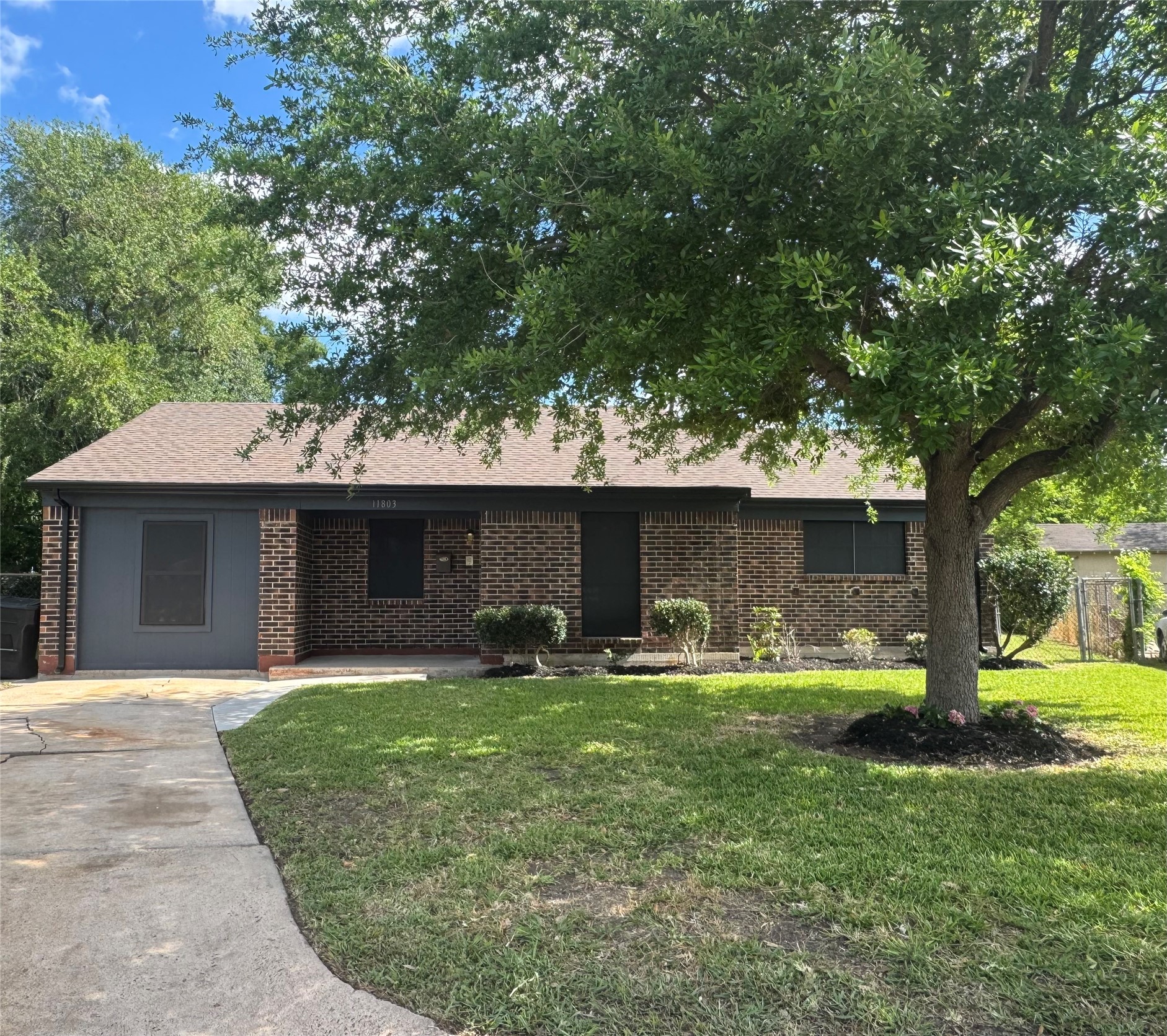 a front view of a house with patio and garden