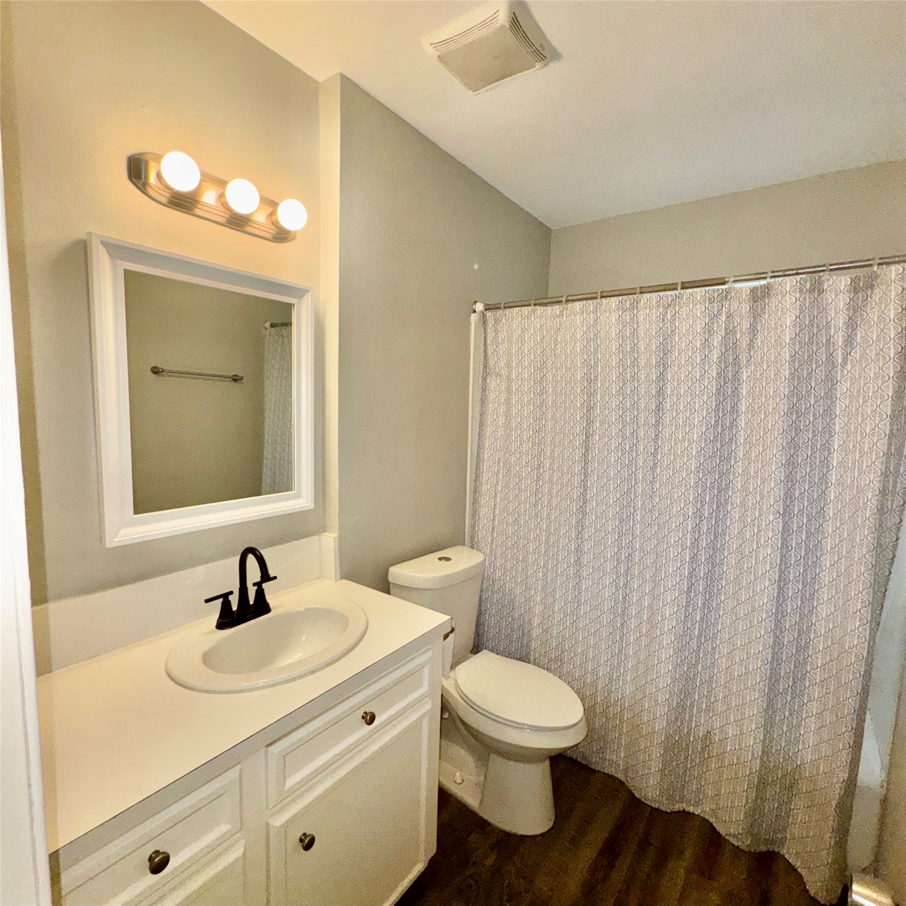 11803 Edgar Street Houston, TX 77047 - Photo 12 of 14 a bathroom with a toilet sink and mirror