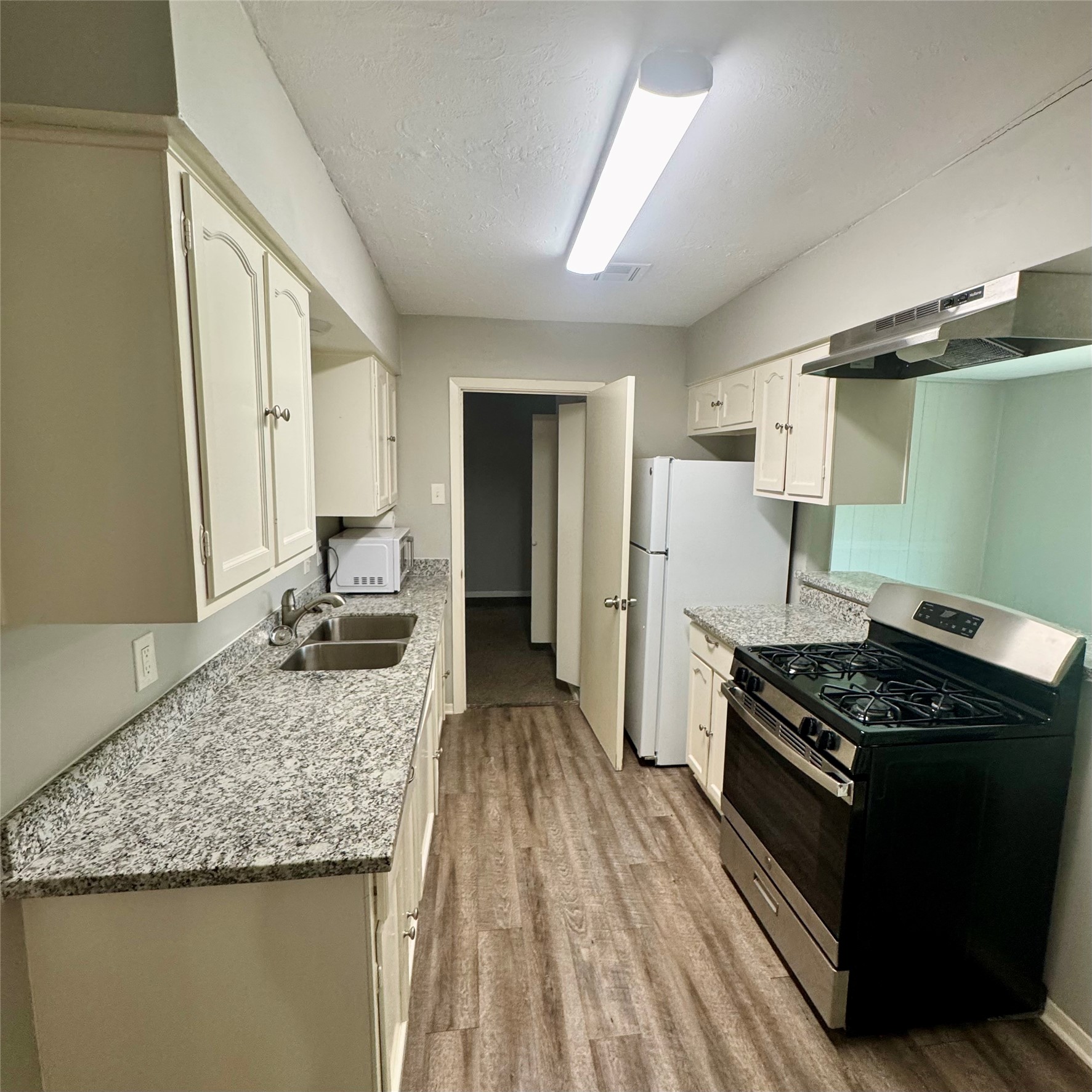 11803 Edgar Street Houston, TX 77047 - Photo 3 of 14 a kitchen with a stove and a white refrigerator