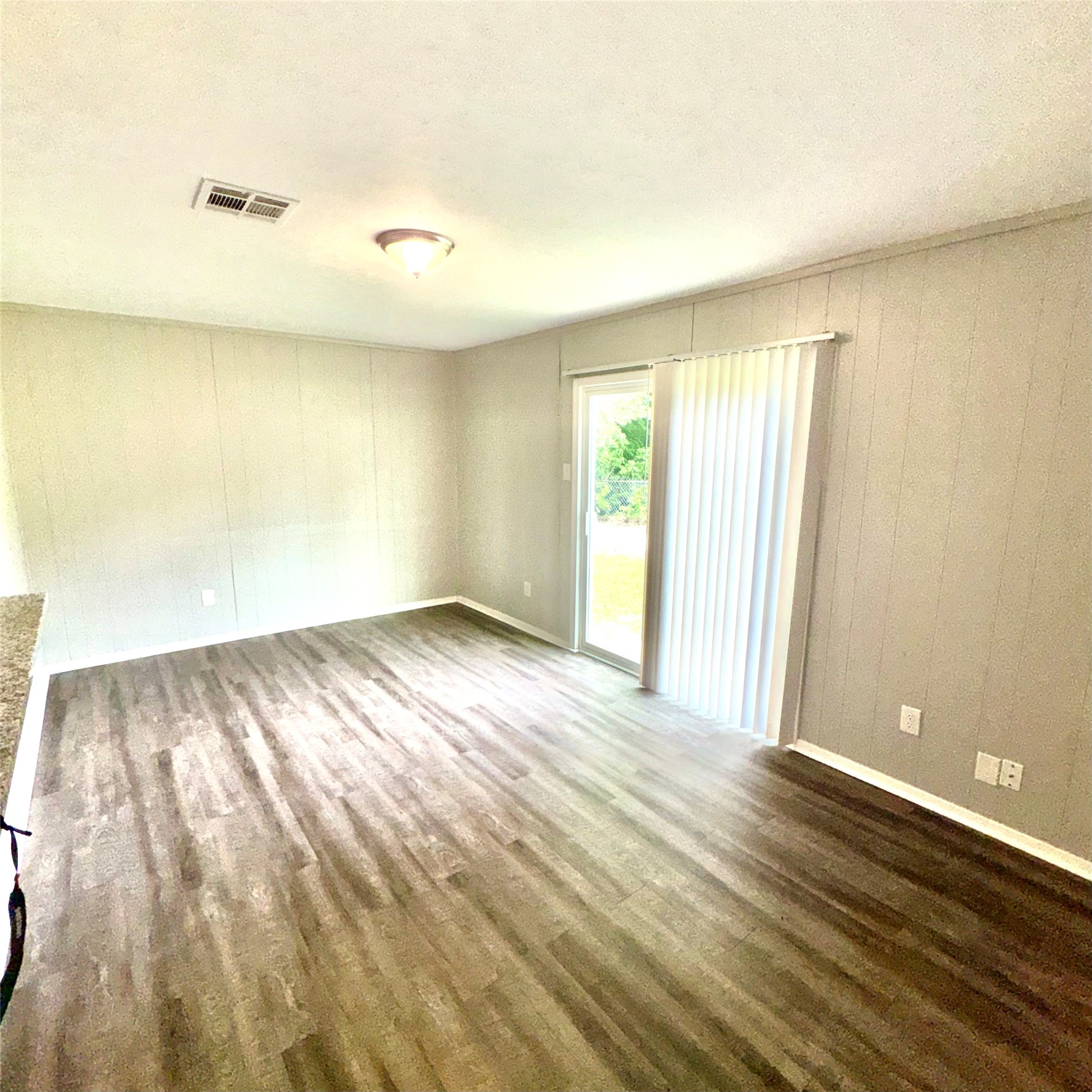 11803 Edgar Street Houston, TX 77047 - Photo 5 of 14 an empty room with wooden floor and windows