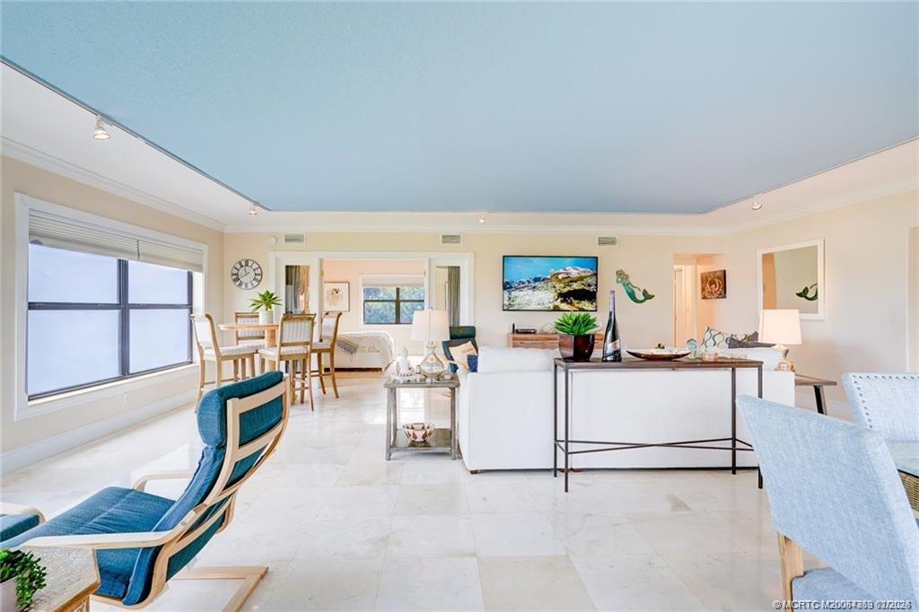 1289 Northeast Ocean Boulevard, Unit 6 Stuart, FL 34996 - Photo 11 of 55 a living room with furniture a large window and kitchen view