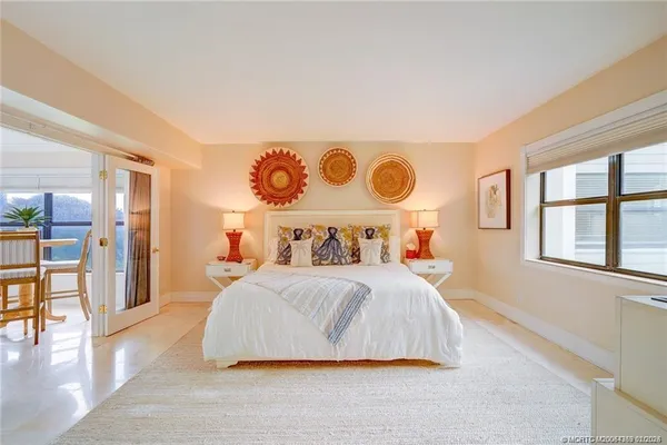 a bedroom with a large bed and a window