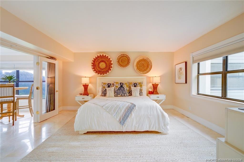 1289 Northeast Ocean Boulevard, Unit 6 Stuart, FL 34996 - Photo 19 of 55 a bedroom with a large bed and a window