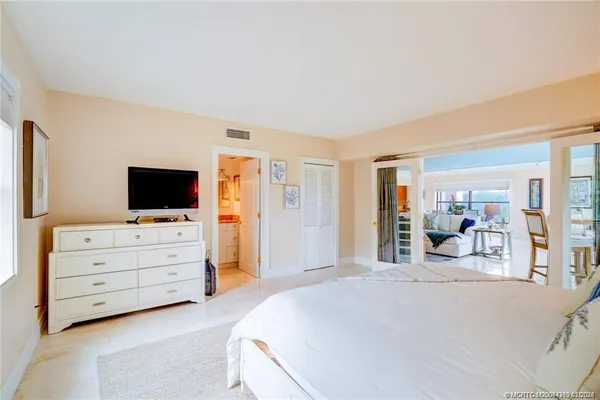 a bedroom with furniture and flat screen tv