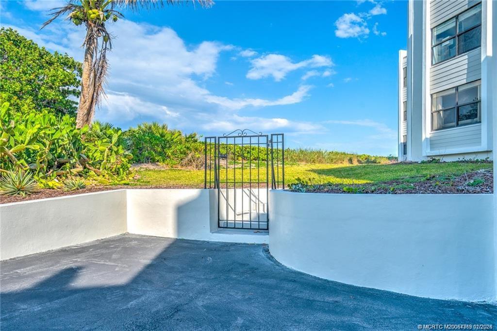 1289 Northeast Ocean Boulevard, Unit 6 Stuart, FL 34996 - Photo 54 of 55 a view of a swimming pool with a yard