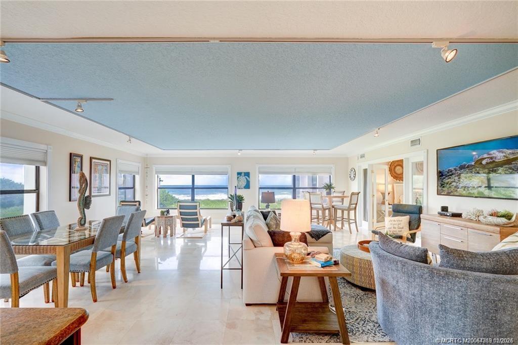 1289 Northeast Ocean Boulevard, Unit 6 Stuart, FL 34996 - Photo 7 of 55 a living room with furniture and a large window