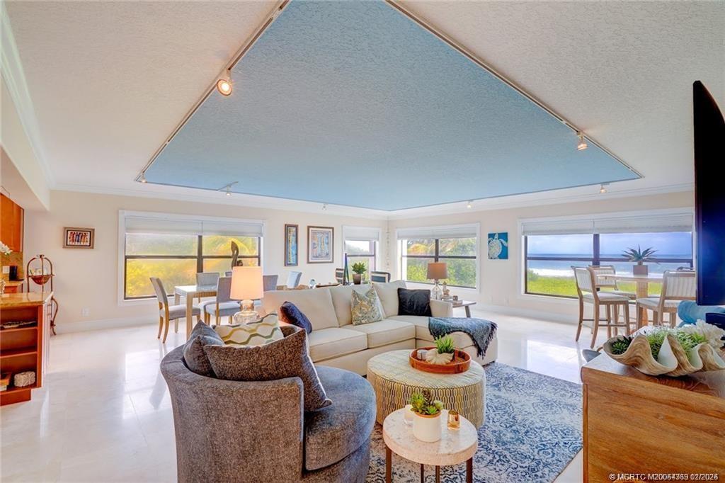 1289 Northeast Ocean Boulevard, Unit 6 Stuart, FL 34996 - Photo 8 of 55 a living room with furniture and a large window