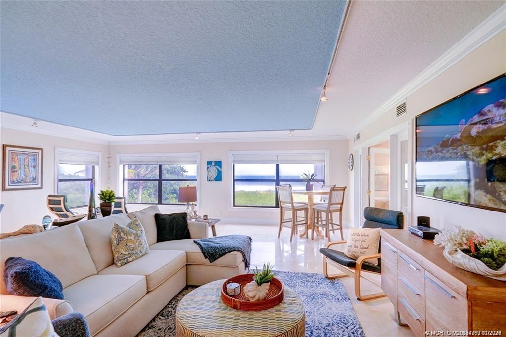 1289 Northeast Ocean Boulevard, Unit 6 Stuart, FL 34996 - Photo 9 of 55 a living room with furniture and a window