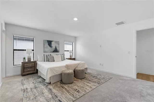 a bedroom with a large bed and a window