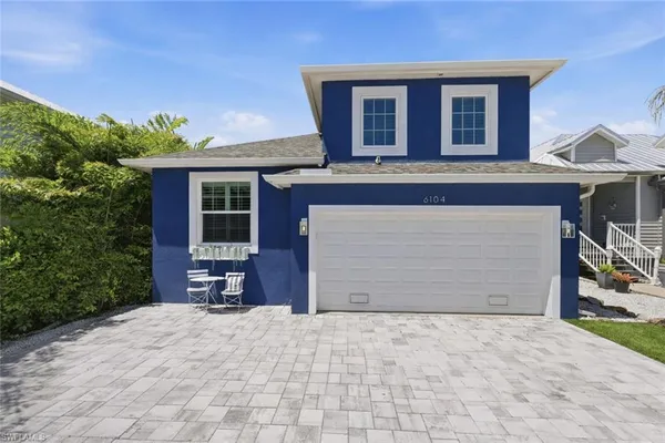 a view of a house with a yard and garage