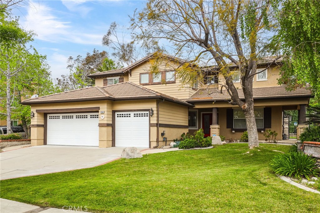 12558 Parke Circle Rancho Cucamonga, CA 91739 - Photo 1 of 1 a front view of a house with garden and trees