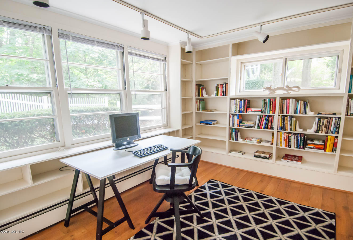 4 Ridgebrook Road Greenwich, CT 06830 - Photo 7 of 17 a workspace with a bookshelf or chandelier and a window