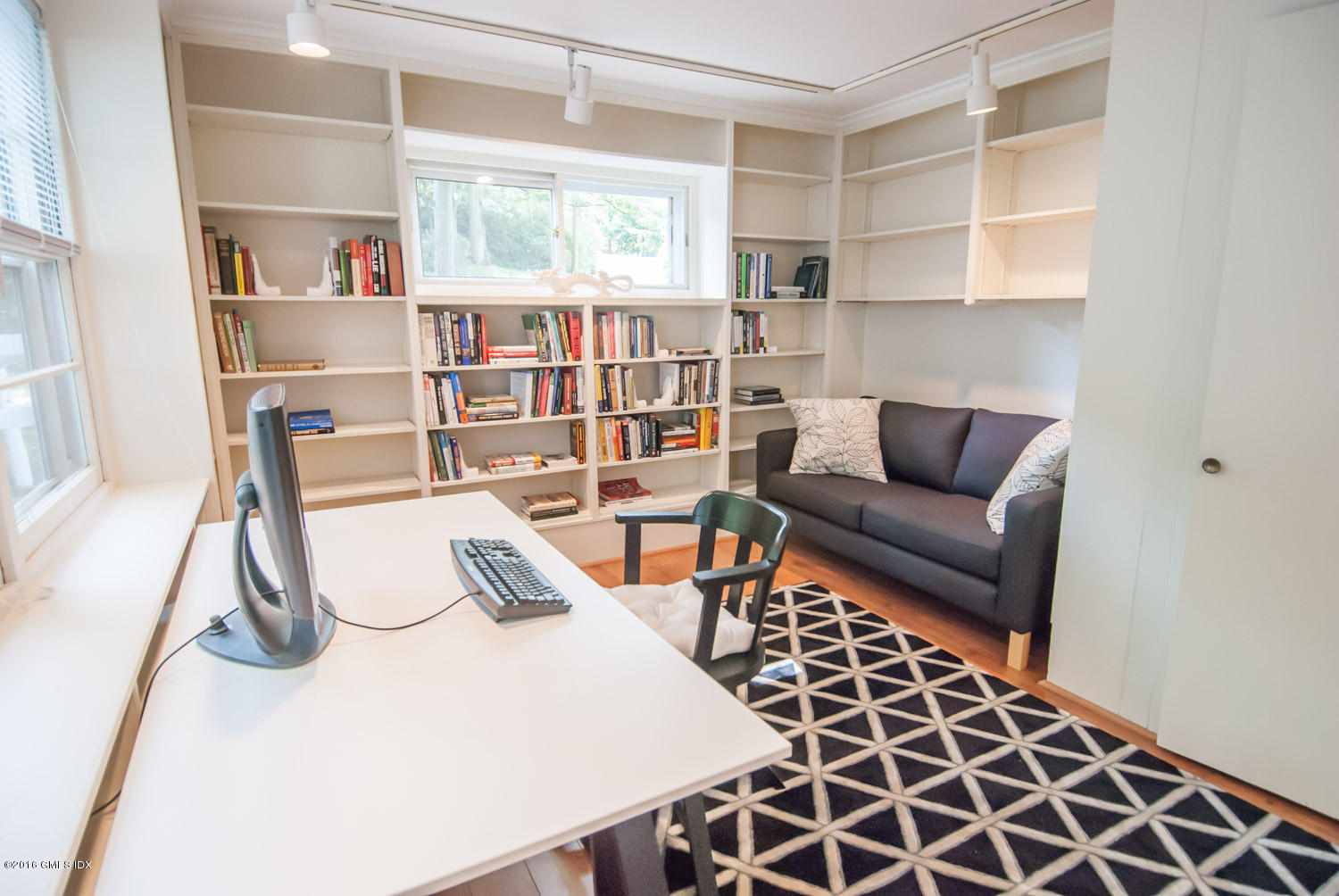 4 Ridgebrook Road Greenwich, CT 06830 - Photo 8 of 17 a living room with furniture a rug and a book shelf