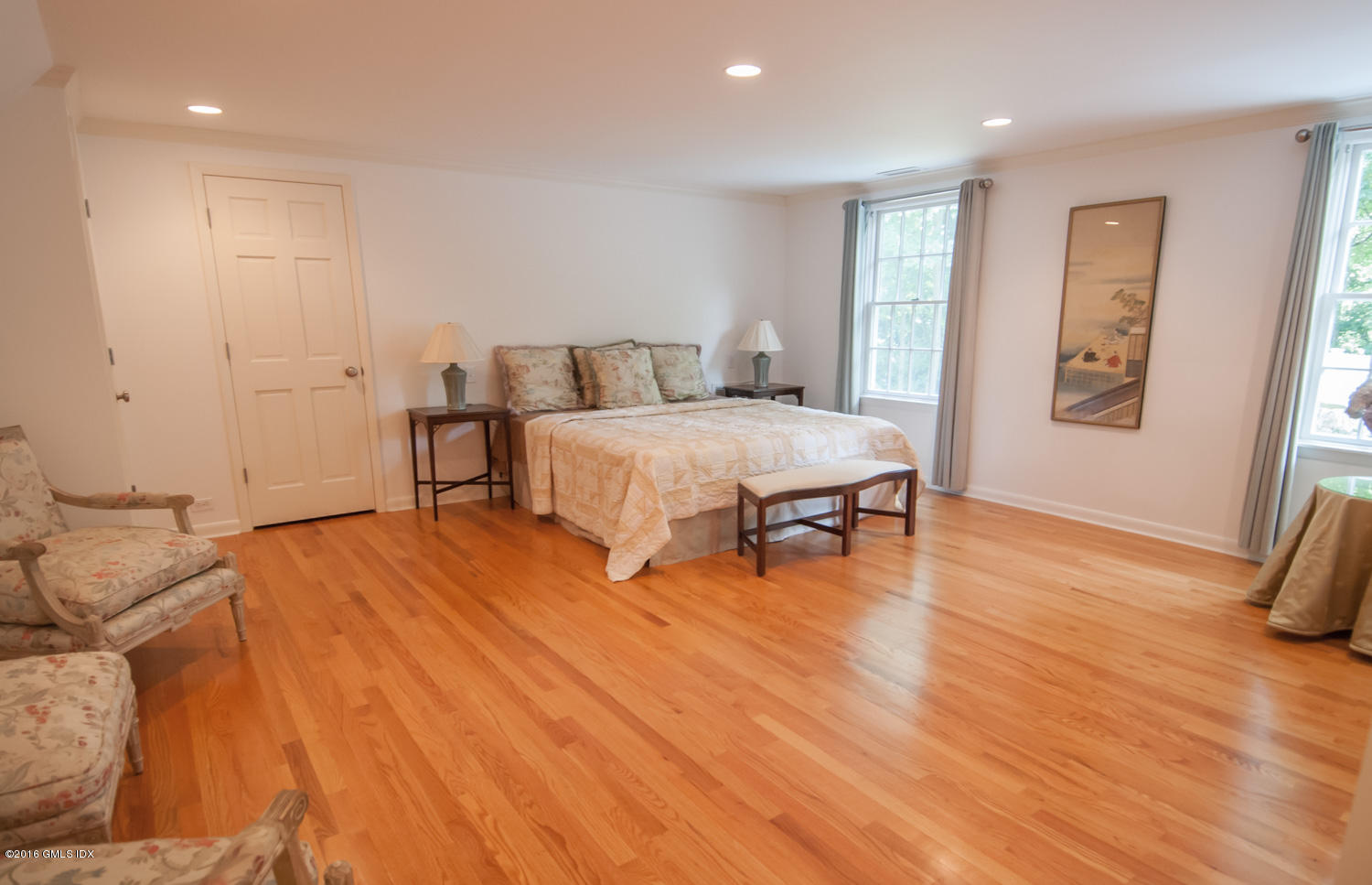 4 Ridgebrook Road Greenwich, CT 06830 - Photo 9 of 17 a spacious bedroom with a bed and a table in it