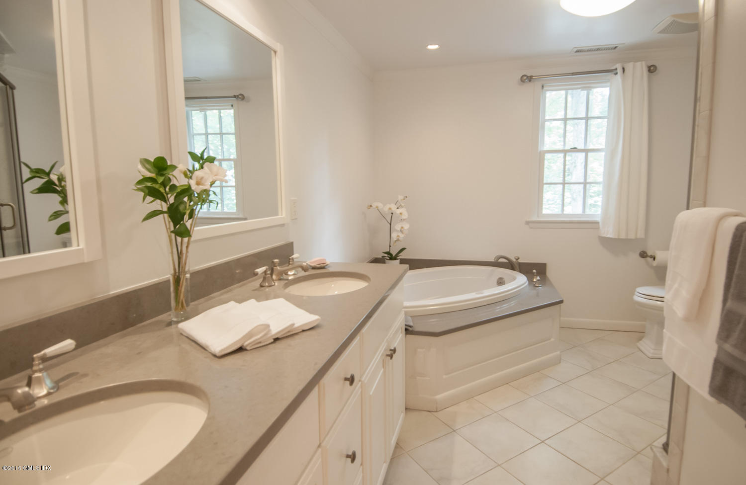 4 Ridgebrook Road Greenwich, CT 06830 - Photo 10 of 17 a bathroom with a granite countertop sink a toilet and a mirror
