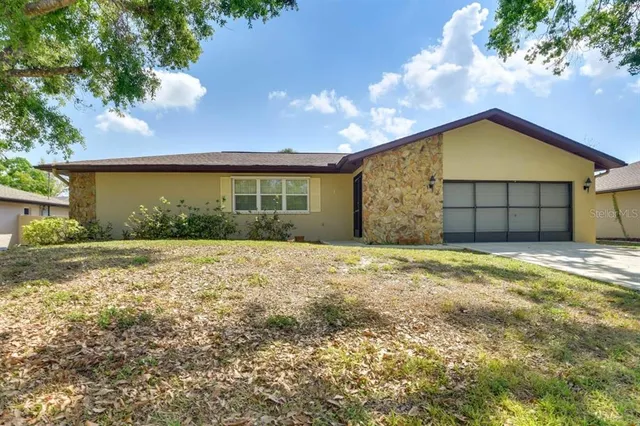 a view of a house with a yard and garage