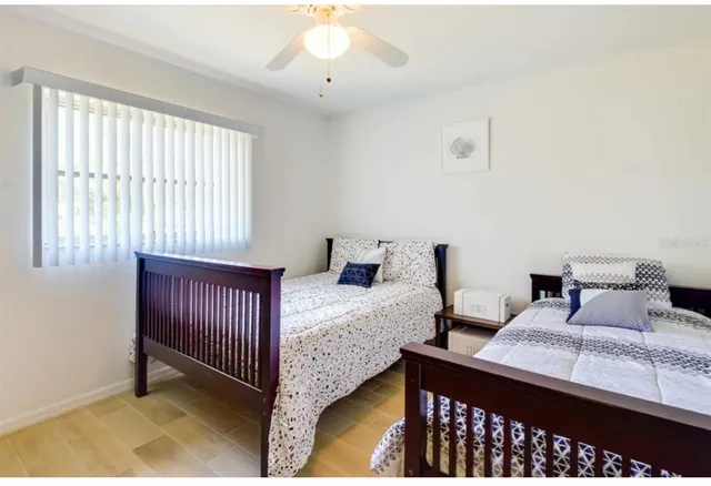 a bedroom with bed and wooden floor