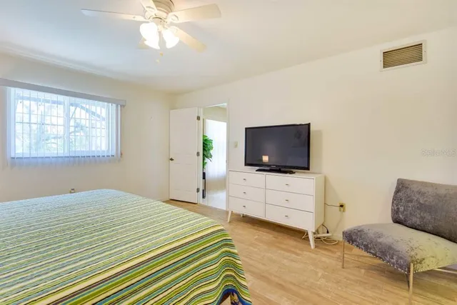 a bedroom with furniture and a flat screen tv