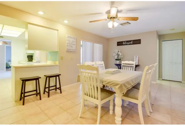 a view of a dining room with furniture and a chandelier