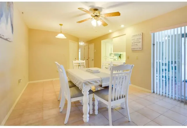 a view of a dining room with furniture and a chandelier