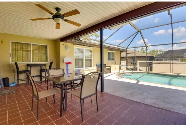 a dining room with furniture and a floor to ceiling window