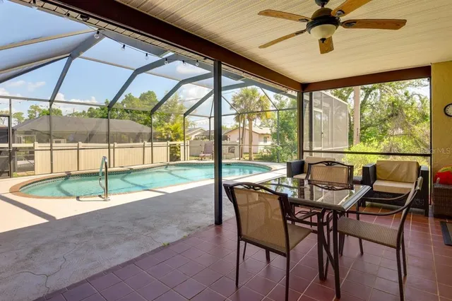 a dining room with furniture and a backyard