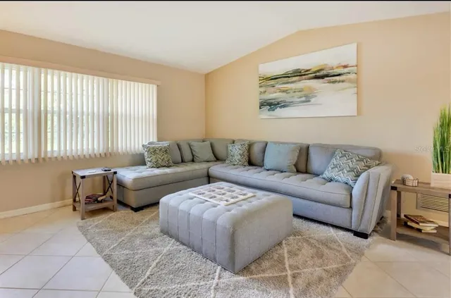 a living room with furniture and a large window
