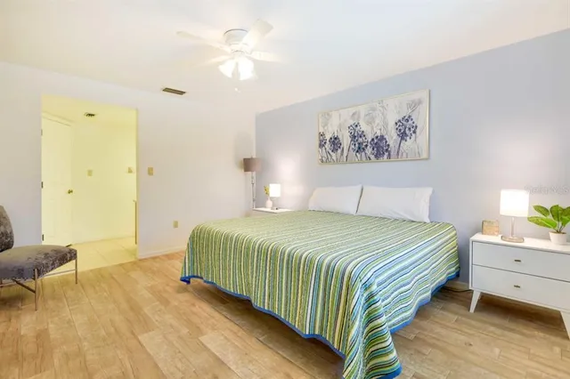 a bedroom with a large bed and a chandelier