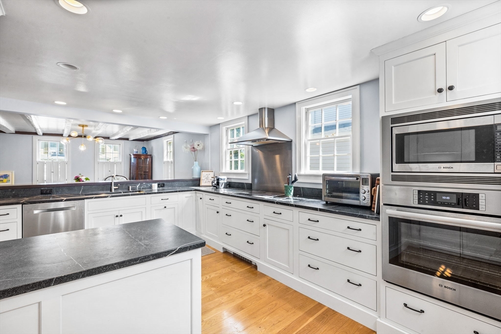 17 Pleasant Street Hingham, MA 02043 - Photo 12 of 41 a kitchen with granite countertop a stove microwave and cabinets