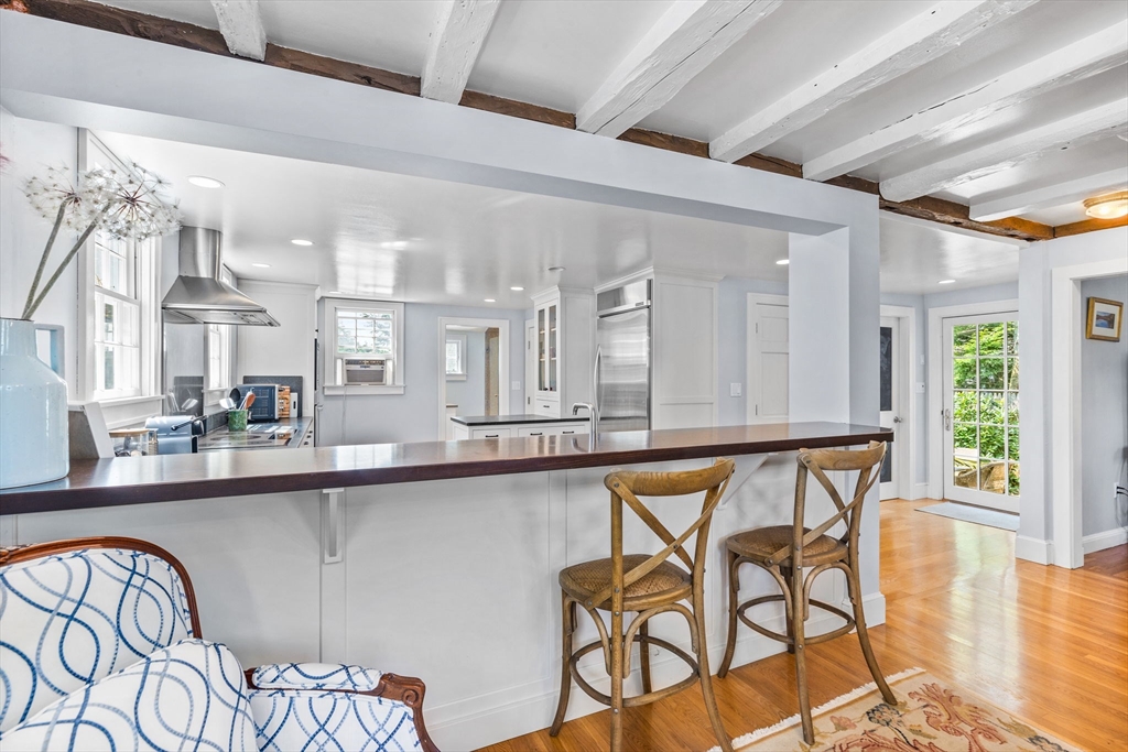 17 Pleasant Street Hingham, MA 02043 - Photo 19 of 41 a dining hall with stainless steel appliances granite countertop a dining table and chairs with wooden floor
