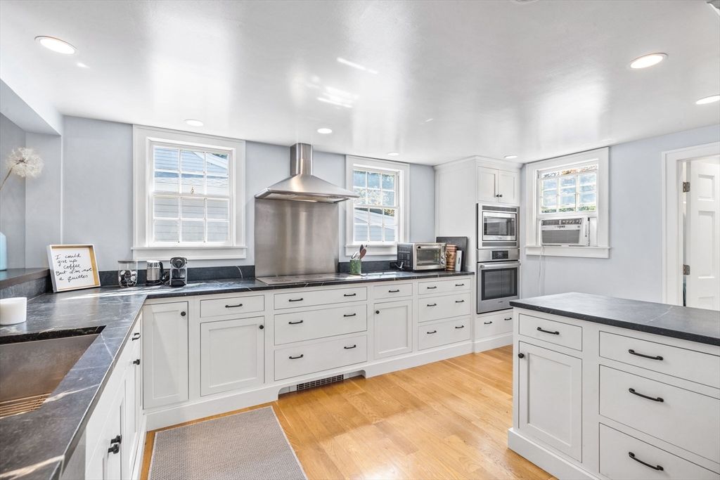 17 Pleasant Street Hingham, MA 02043 - Photo 2 of 41 a kitchen with granite countertop white cabinets sink and stainless steel appliances