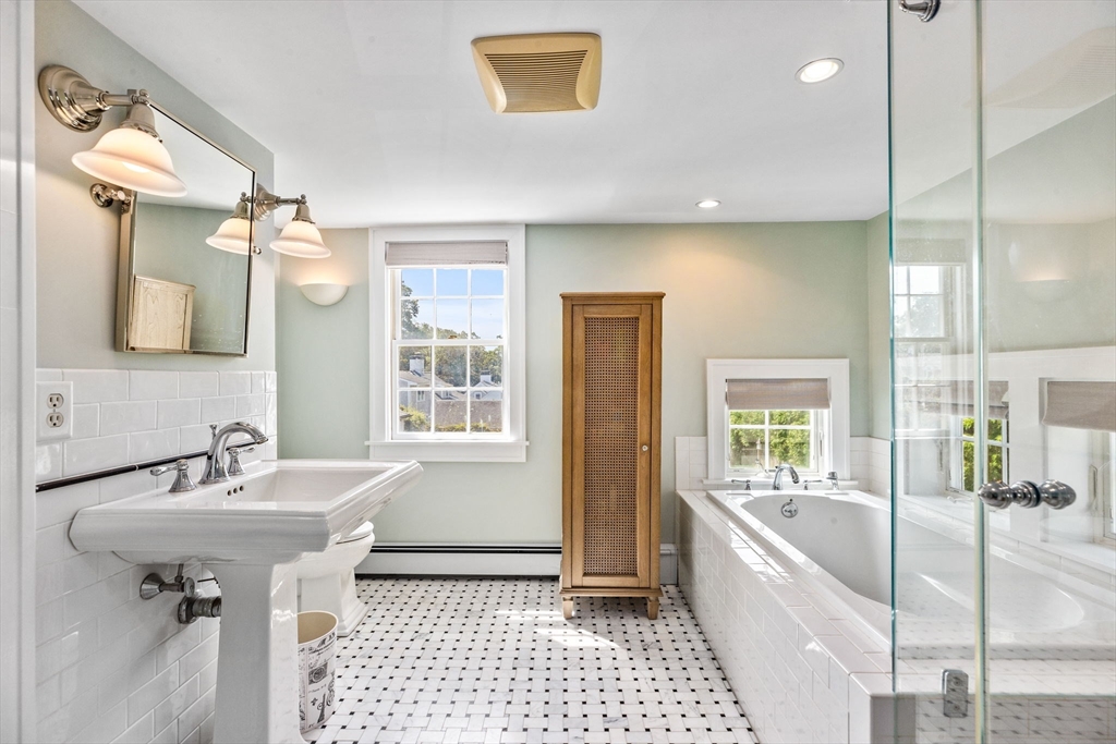 17 Pleasant Street Hingham, MA 02043 - Photo 22 of 41 a bathroom with a sink a mirror and a bathtub
