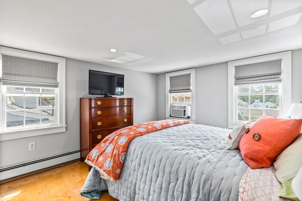 17 Pleasant Street Hingham, MA 02043 - Photo 27 of 41 a bedroom with a bed and wooden floor