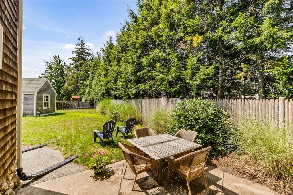 17 Pleasant Street Hingham, MA 02043 - Photo 36 of 41 a view of a patio with table and chairs with wooden fence and plants