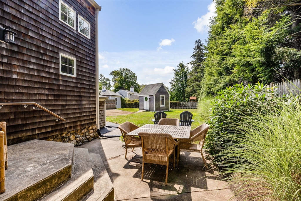 17 Pleasant Street Hingham, MA 02043 - Photo 37 of 41 a view of a patio with table and chairs and potted plants with wooden fence