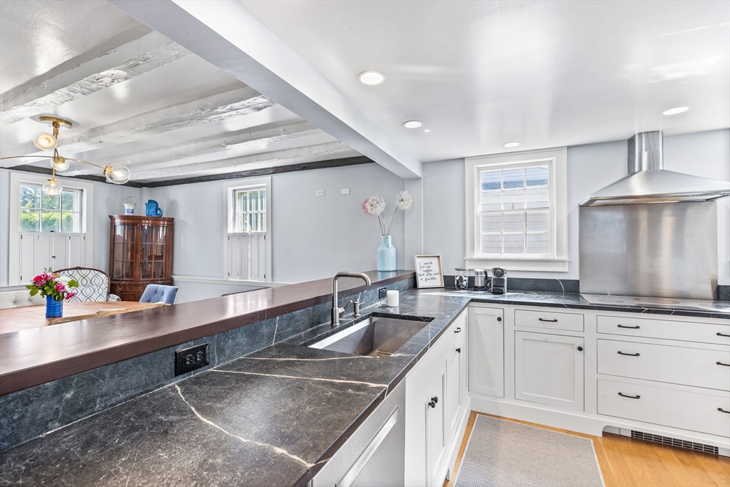 17 Pleasant Street Hingham, MA 02043 - Photo 5 of 41 a kitchen with granite countertop a sink a stove and cabinets