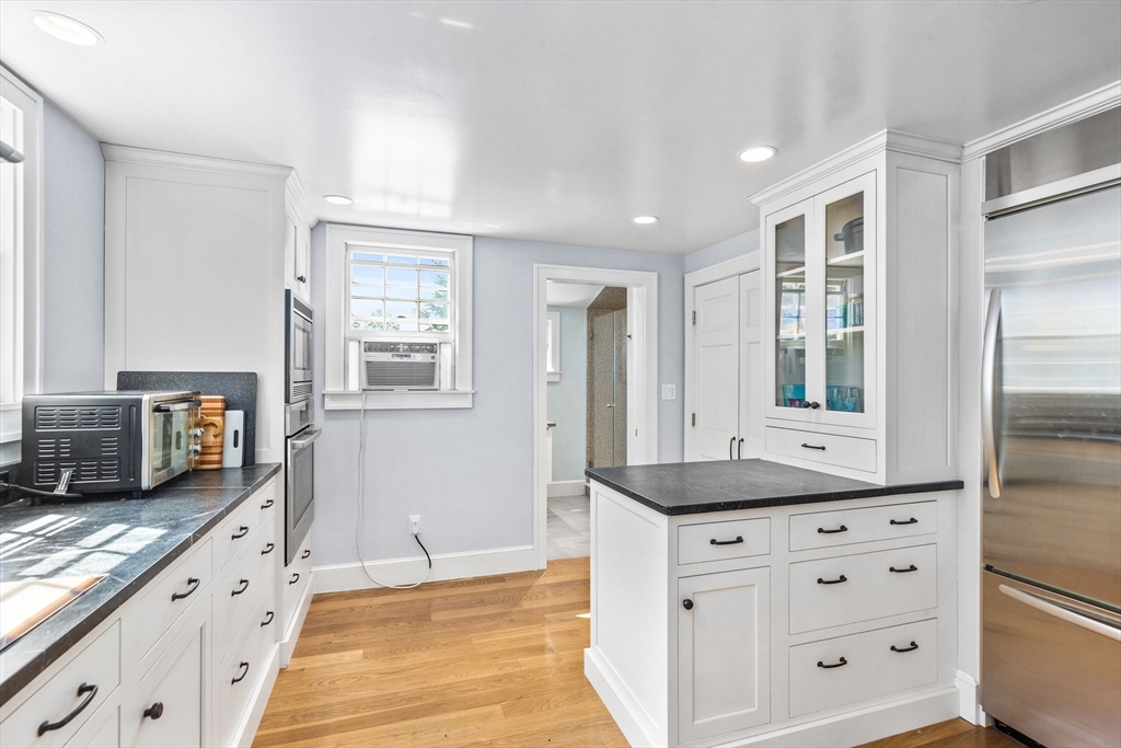 17 Pleasant Street Hingham, MA 02043 - Photo 6 of 41 a kitchen with granite countertop a stove and a sink